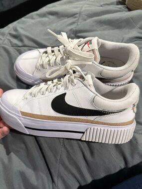 Nike Women's White Sneakers with Black Swoosh and Tan Trim